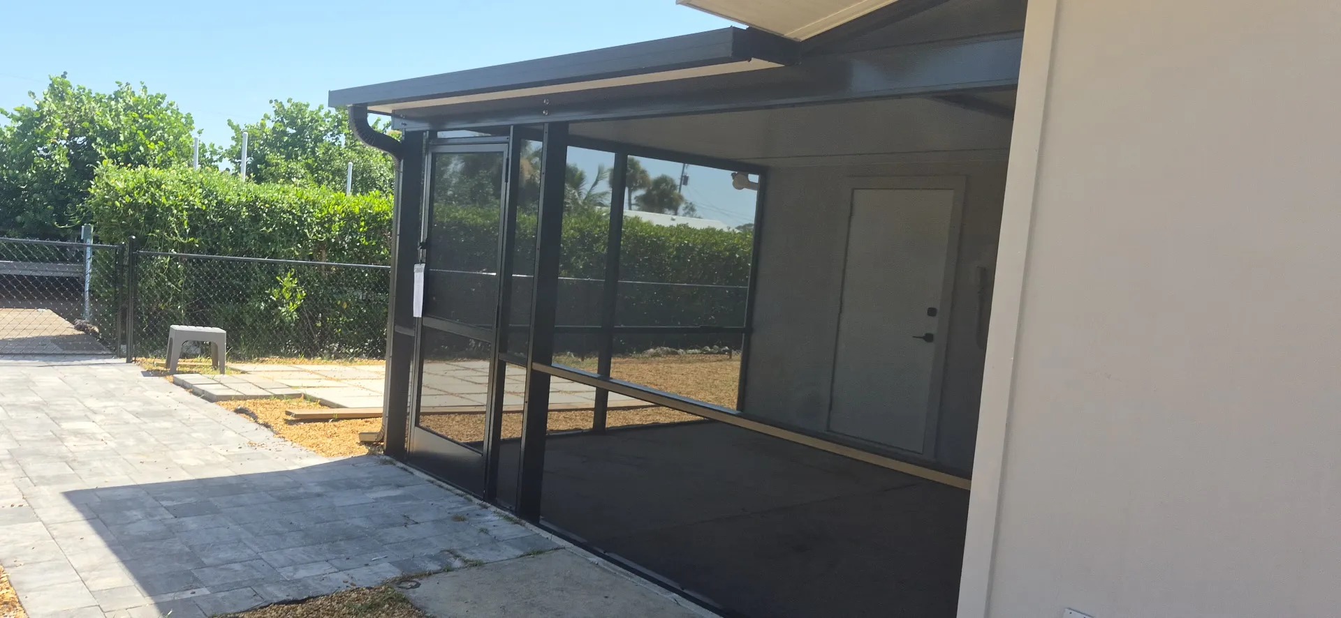 Exterior side view of a screen enclosure and lanai in Englewood, FL