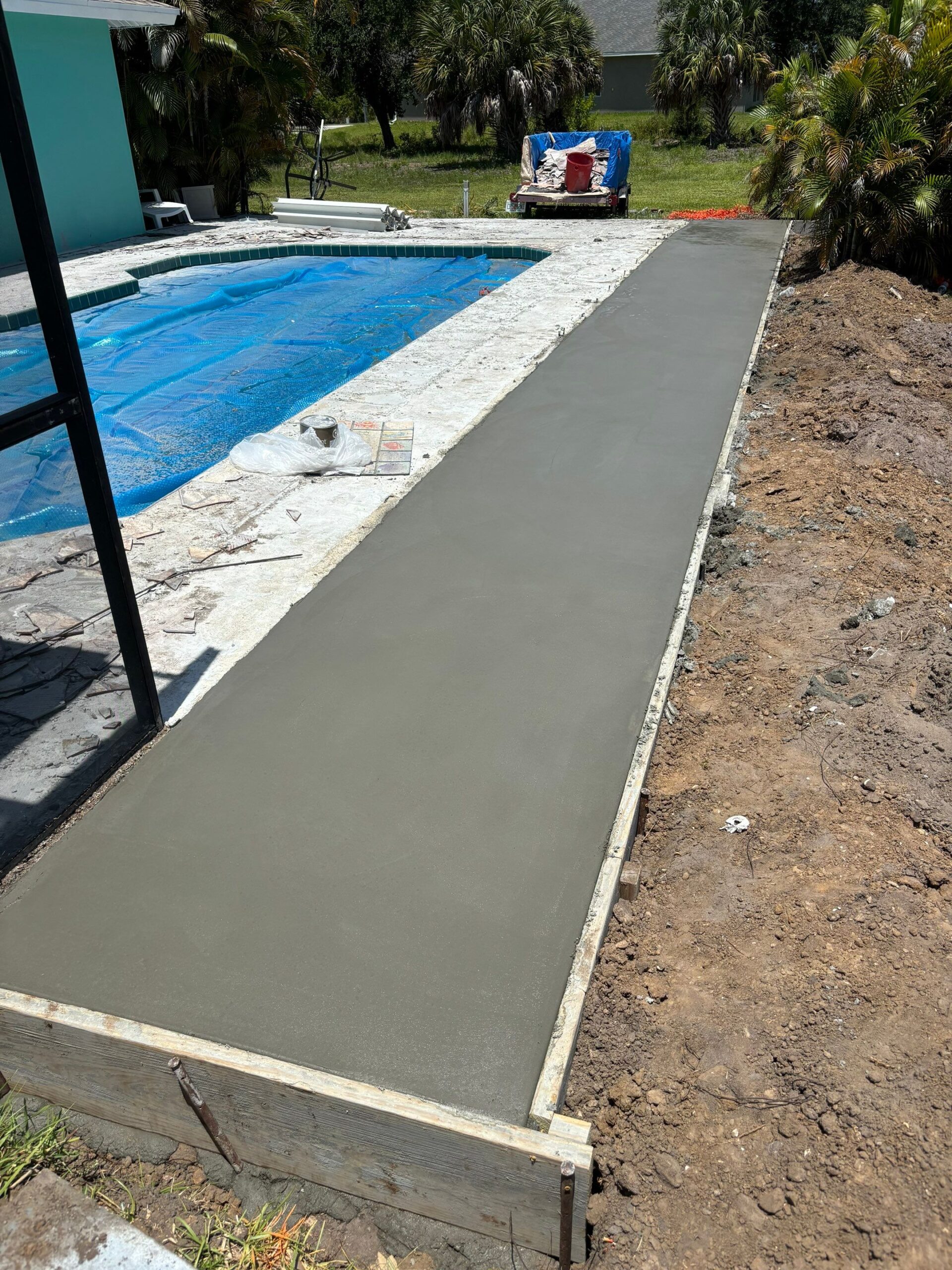 New concrete walkway beside pool in Port Charlotte, FL