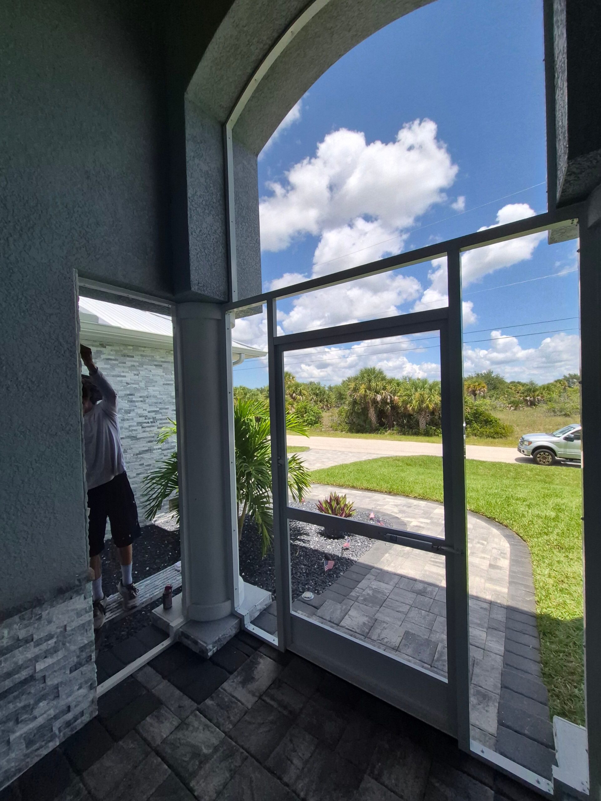 Screened entryway porch with view of front yard in Port Charlotte, FL