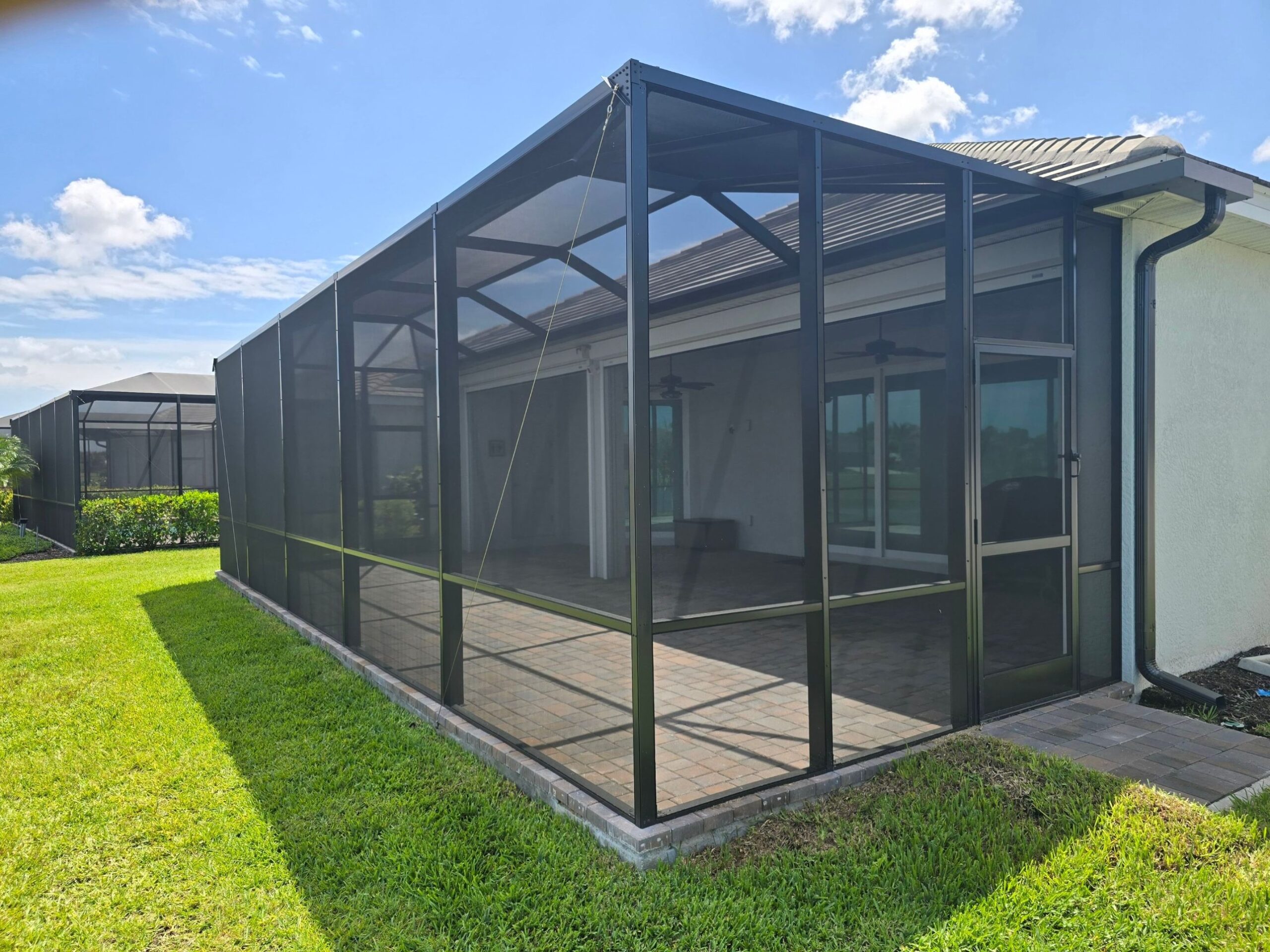 Gable-roof screen enclosure over a paver lanai in Heritage Landing, Punta Gorda, FL, built by Screen Experts, LLC