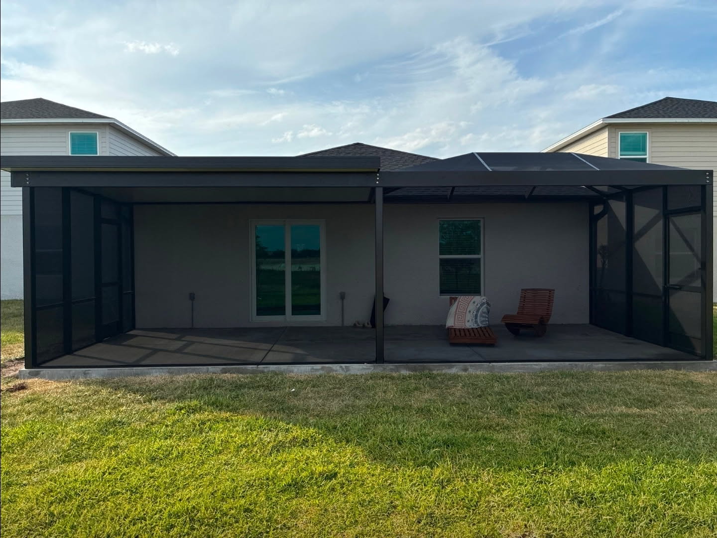 Screen enclosure with a half composite roof and half screen roof over a lanai in Punta Gorda, FL, built by Screen Experts, LLC